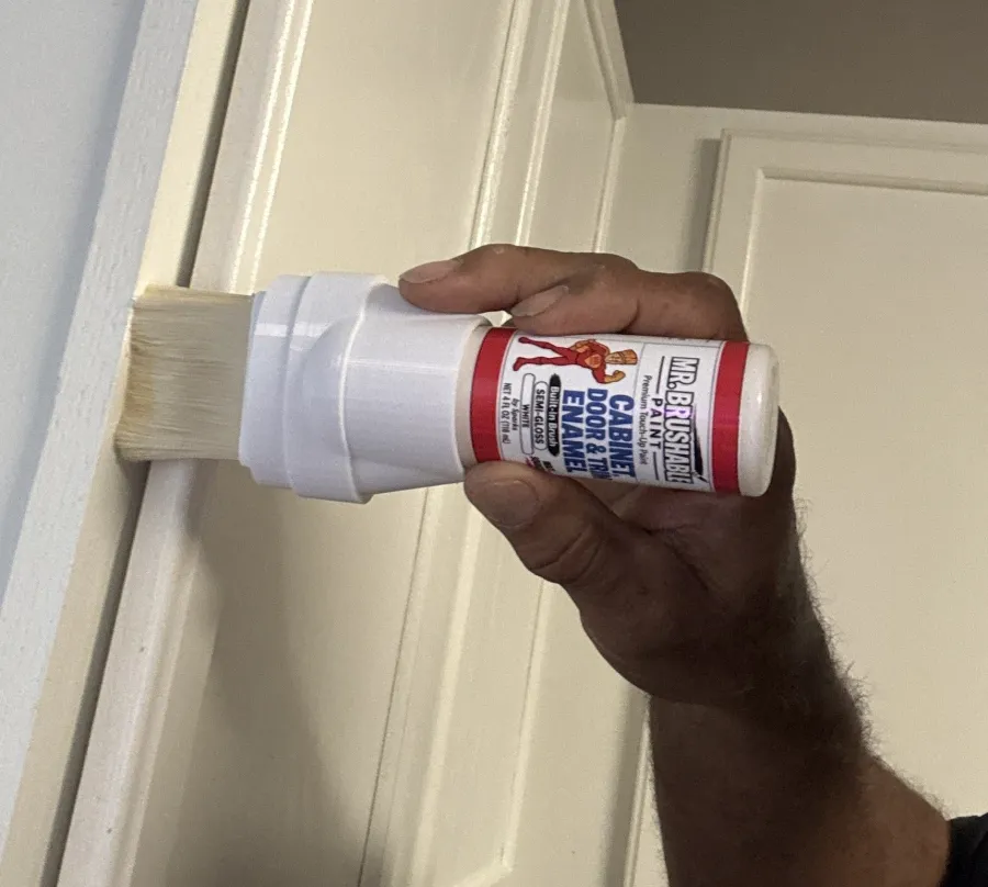 Touching up a white door edge with the Mr. Brushable enamel bottle
