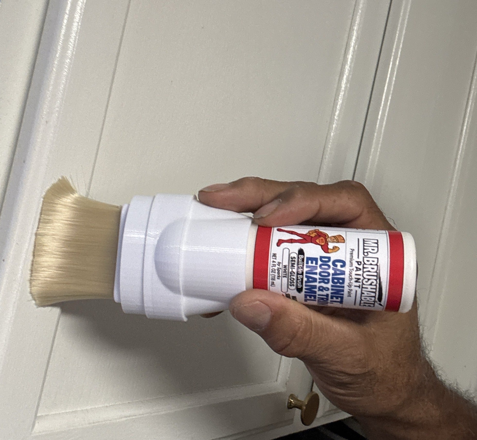 Brushing Mr. Brushable white enamel onto a white door straight from the bottle