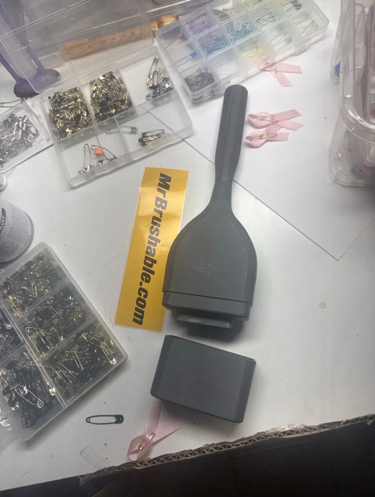 The first 3D-printed Mr. Brushable bottle with built-in brush on the workbench