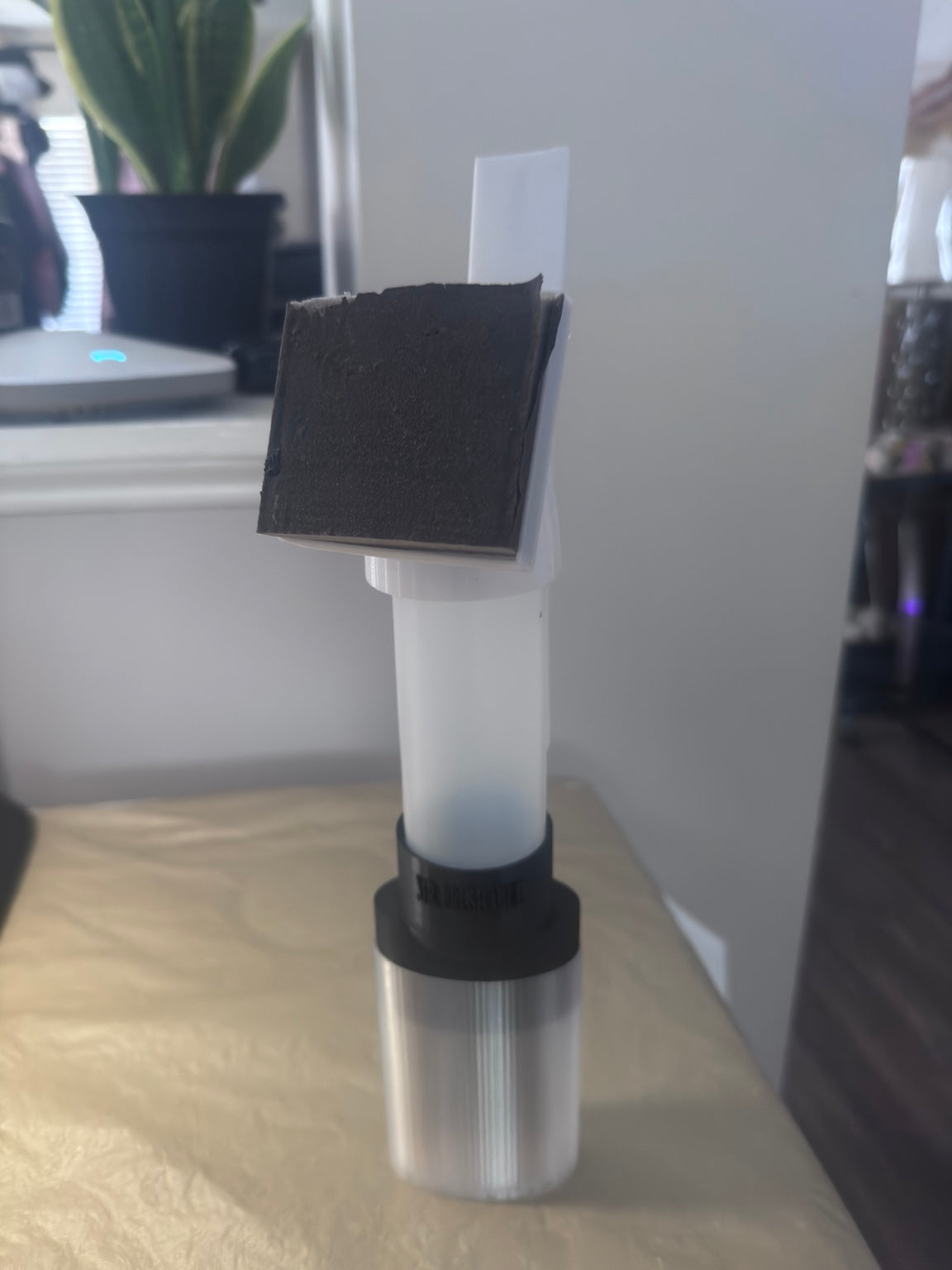 The flip-up sanding head of the Mr. Brushable wall repair kit